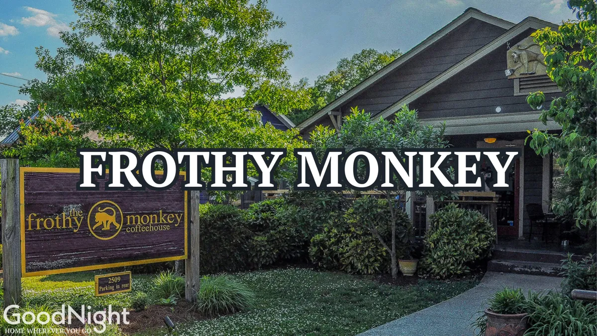 The exterior of Frothy Monkey, a well-known local coffee shop, with its inviting entrance pathway and surrounding greenery. Outdoor seating hints at a relaxed, community-oriented atmosphere — perfect for morning coffee rituals or casual studying.