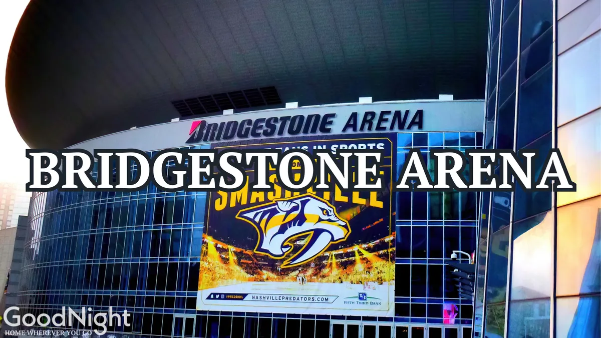 A dynamic shot of the Bridgestone Arena’s modern exterior, featuring its distinctive signage and a large promotional banner. The building stands as a landmark for both major concerts and sports events in Nashville.