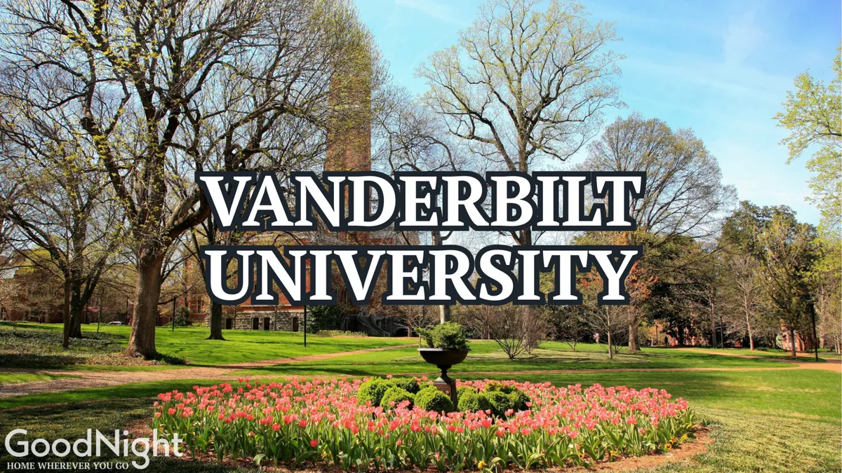 A tranquil exterior view featuring a fountain, colorful flower beds, trees, and a brick tower. The space conveys a sense of peace and is ideal for studying outdoors, socializing, or simply relaxing amid nature.